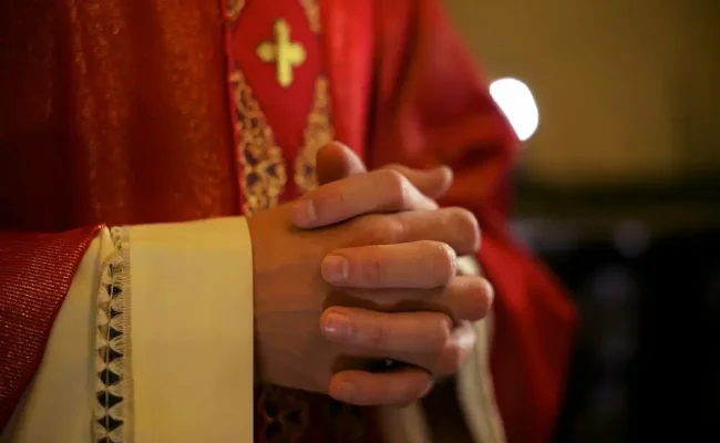 catholic-priest-on-altar-praying-during-mass-2021-08-26-15-46-09-utc.jpg